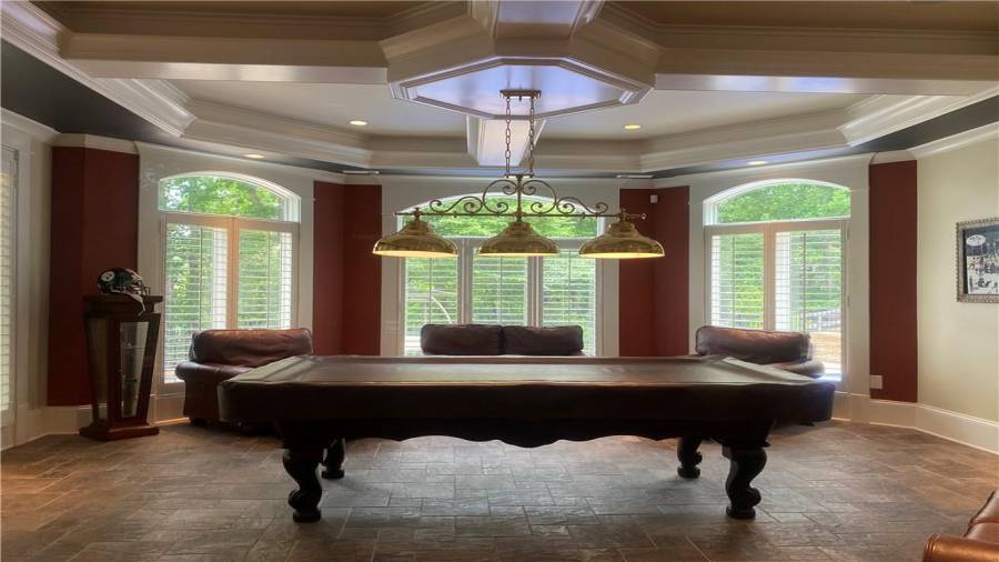 Pool table is located on the terrace level. Tiled floors, beautiful wall of windows and very large. Excellent place to entertain your family and friends.