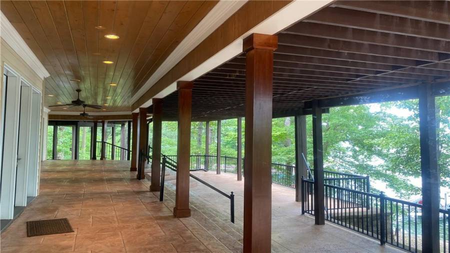 The terrace level outside is just a wonderful setting at the lake. Covered and totally finished and trimmed to perfection. Easy access to the boat dock.