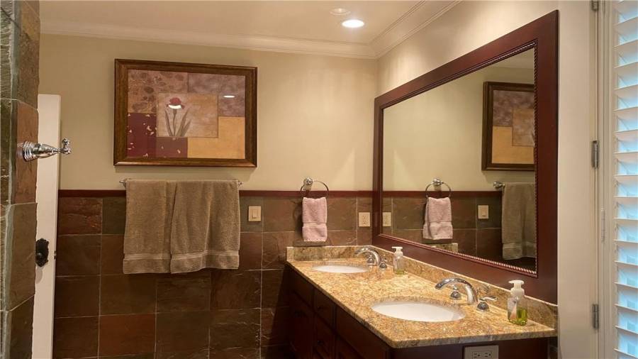 Bath on the terrace level just outside the pool area. No need for your family or guest to go through the home wet.