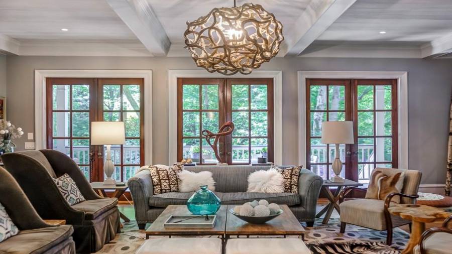 Family room has 3 double and 2 single French doors to wrap around patio making an incredible integration of indoor and outdoor space. Doors are mahogany with custom brass hardware.