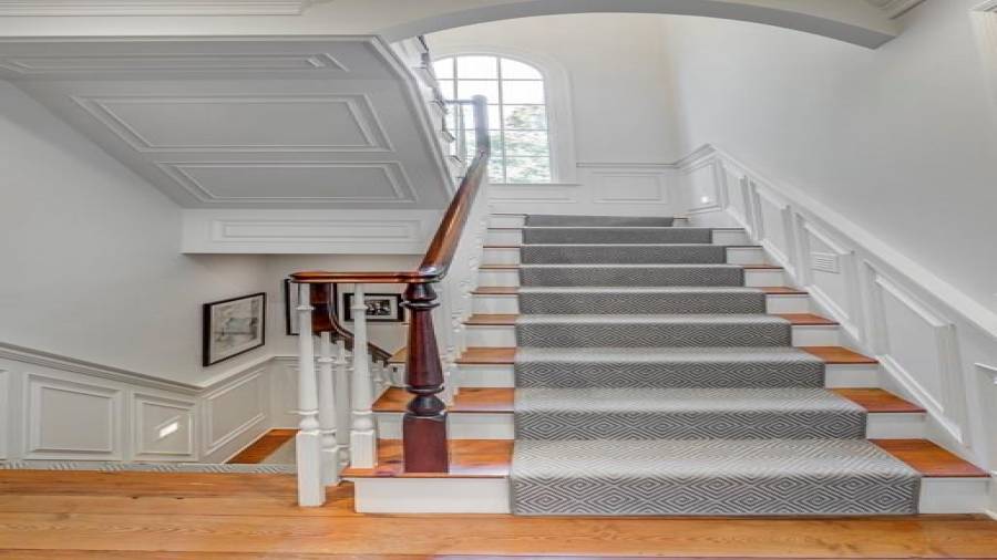 Elegant stair runner and side lighting on stairs going up and down.