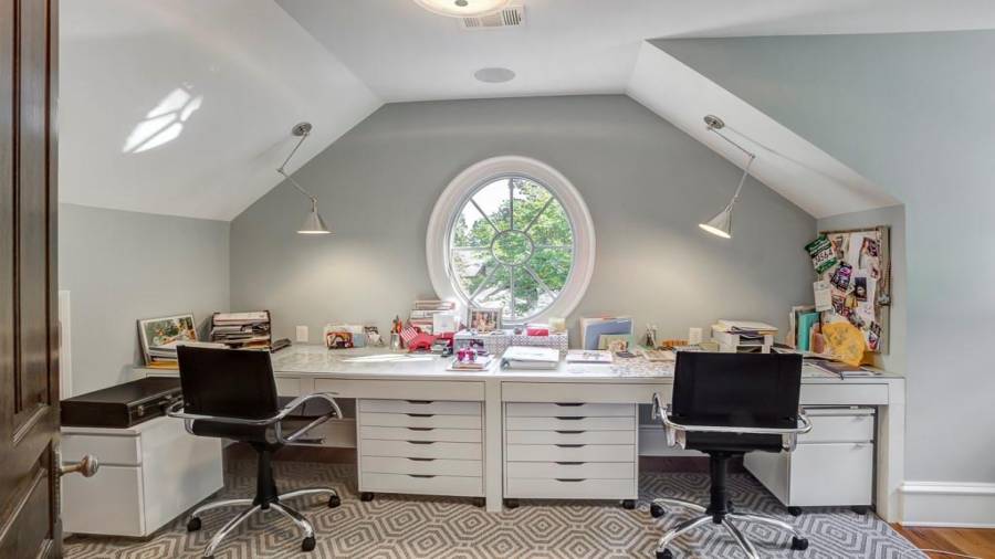 Additional private home office off of primary bedroom closet has double built-in desks.