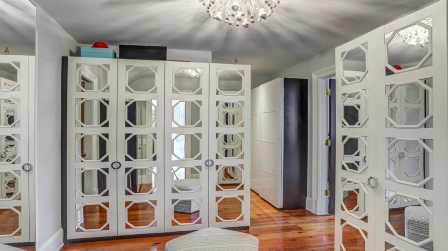 Custom master closet with mirrored doors.