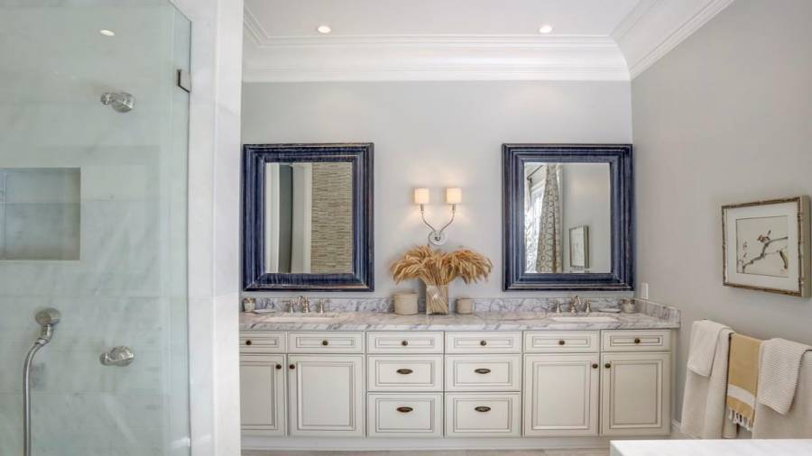 Main level guest ensuite bathroom has double vanities.