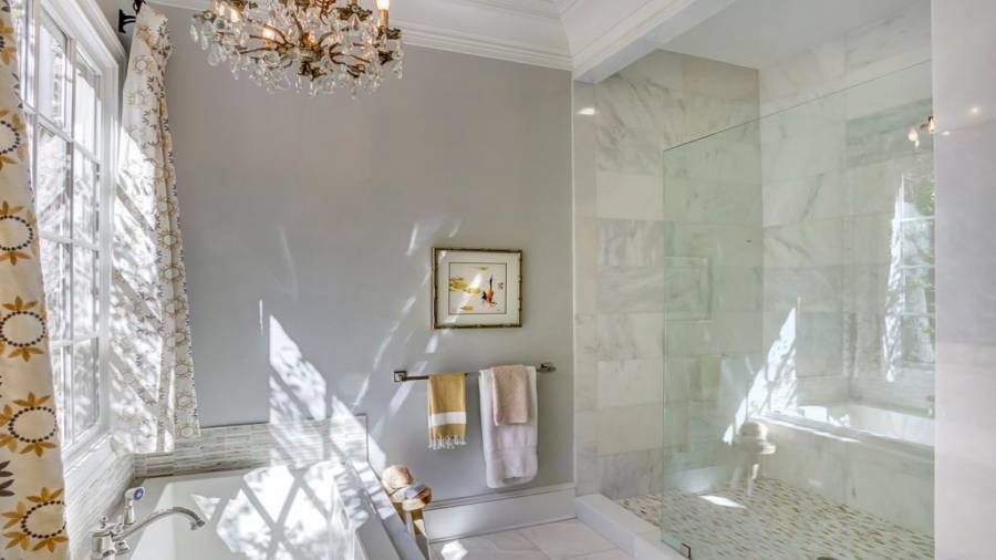 Main level guest ensuite bathroom has separate tub and large walk in shower.