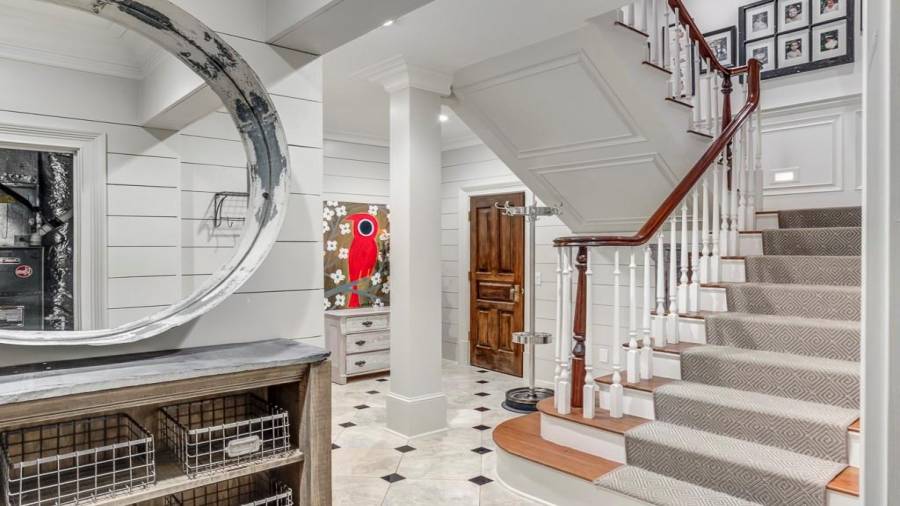 Stairs to lower level, landing and 1 of 2 mudrooms.