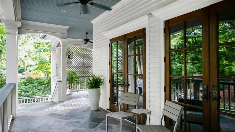 Covered back porch has the Gullah signature sky blue ceiling to bring good luck to the home and help to ward away evil spirits.