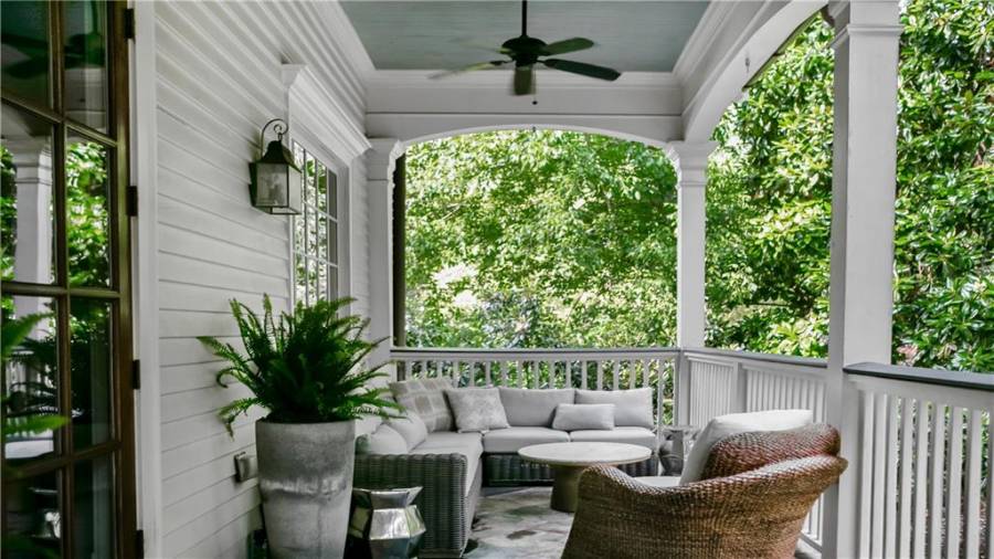 Wrap around porch has plenty of options for living and dining spaces.