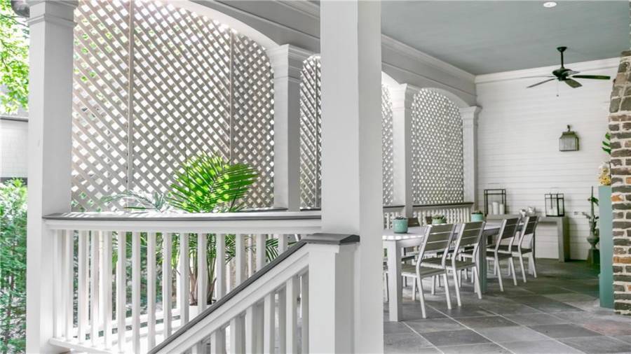 Outdoor covered dining, with door in the back right leading to formal inside dining room.