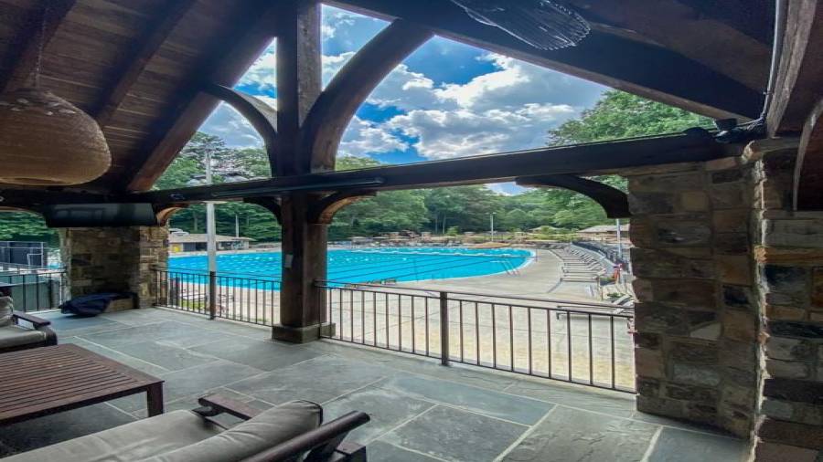 Covered pavilion overlooks pool and tennis.