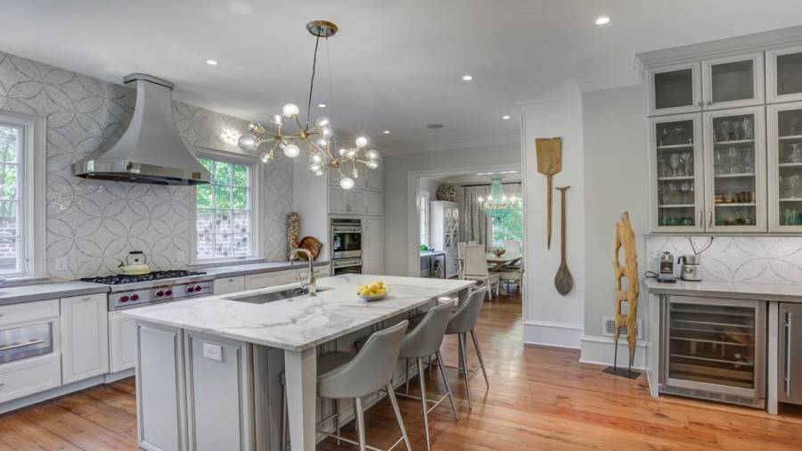 Kitchen with view of casual dining behind. Note the Wolf 6-burner rage, mirror polished Abakka stainless hood, Wolf double ovens, and warming drawer. And casement windows that open!