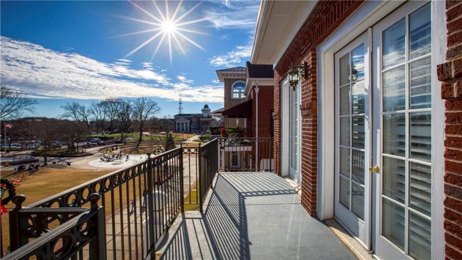 Upstairs condo Unit 1 balcony view of the Town Green