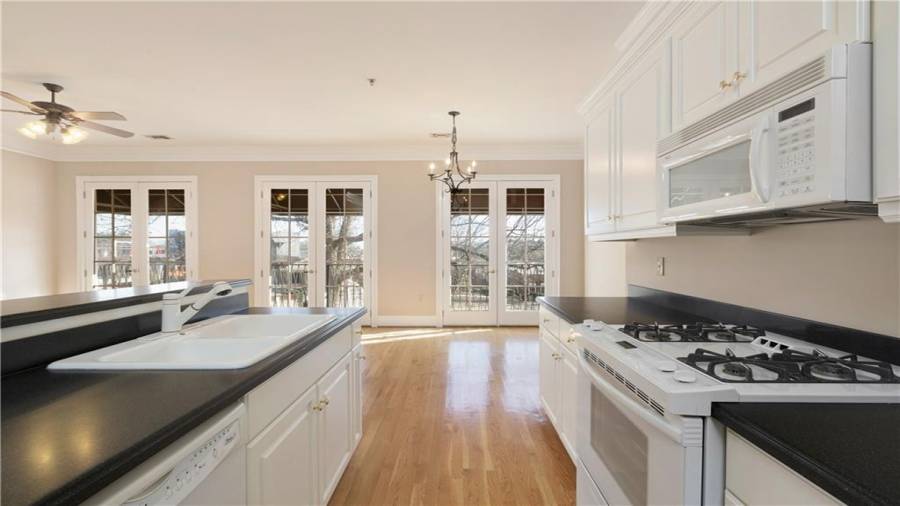 Upstairs condo Unit 2 kitchen with a view towards the balcony doors