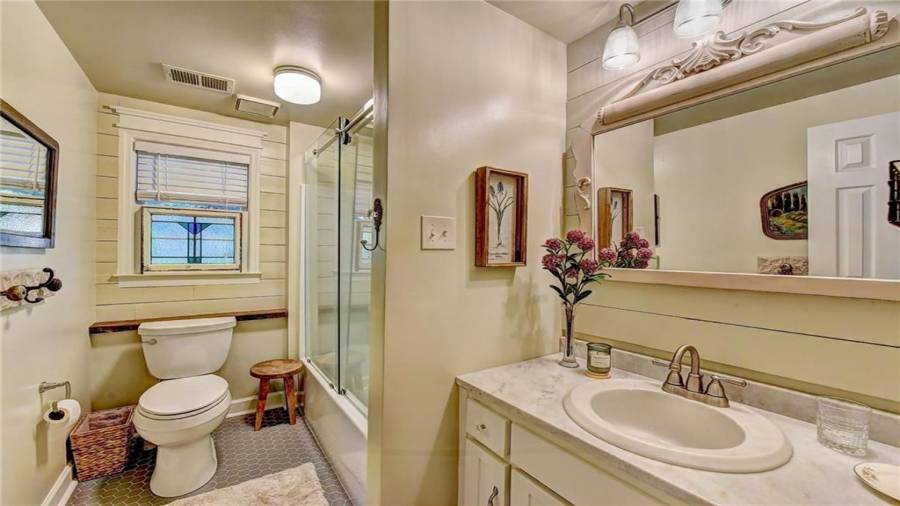 Lower level full bath - updated flooring and frameless shower doors.