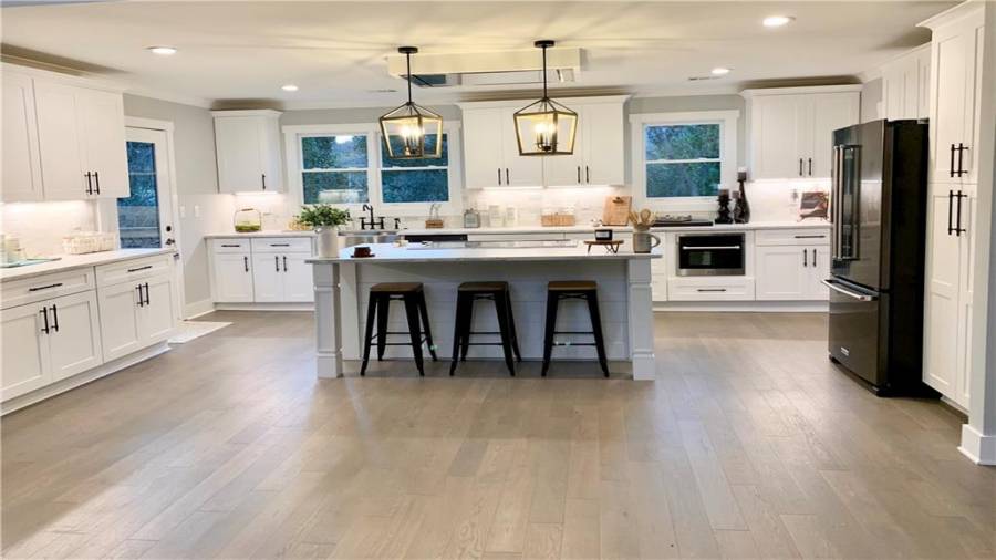 Excellent lighting from can lights, island pendants, ceiling range hood, & under-cabinet lighting