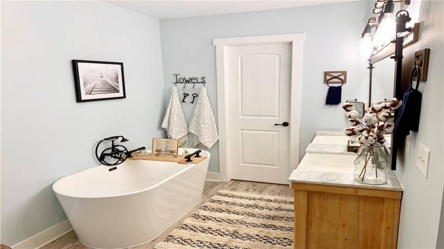 Spa-like master bath offers free standing soaker tub with wall-mount tub filler