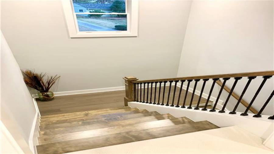 Beautifully stained stair treads in extra-wide staircase to upper level