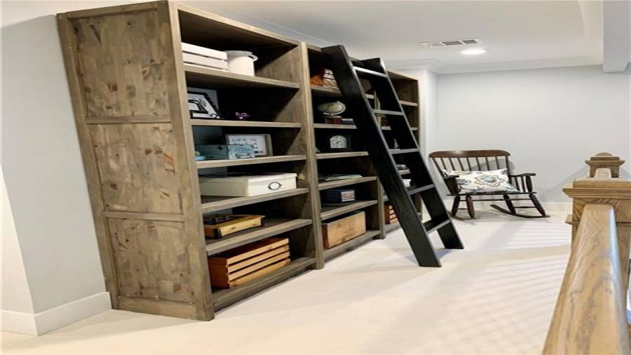Custom built-in bookcase with ladder upstairs