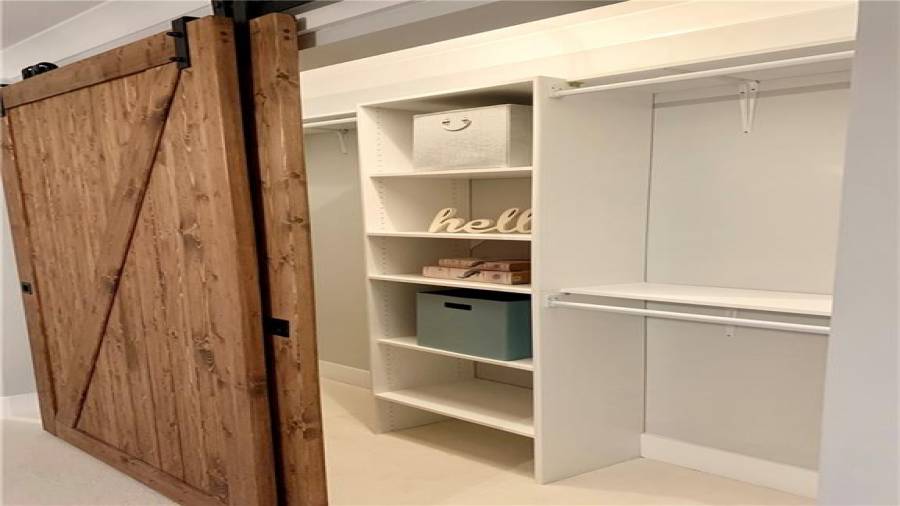 48” double sliding barn doors to bedroom 5 closet. Convenient closet system with tons of storage space