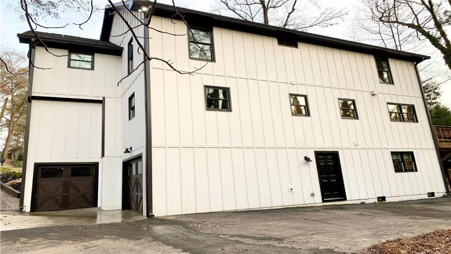 One-car garage and small storage garage on back right of home. Custom Wayne dalton garage doors