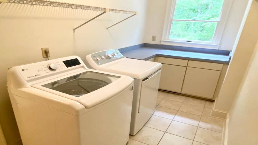 Main Level Laundry room with folding table and built in ironing board