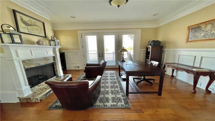 Main floor office with lake views and gas fireplace would make any business executive feel like home.