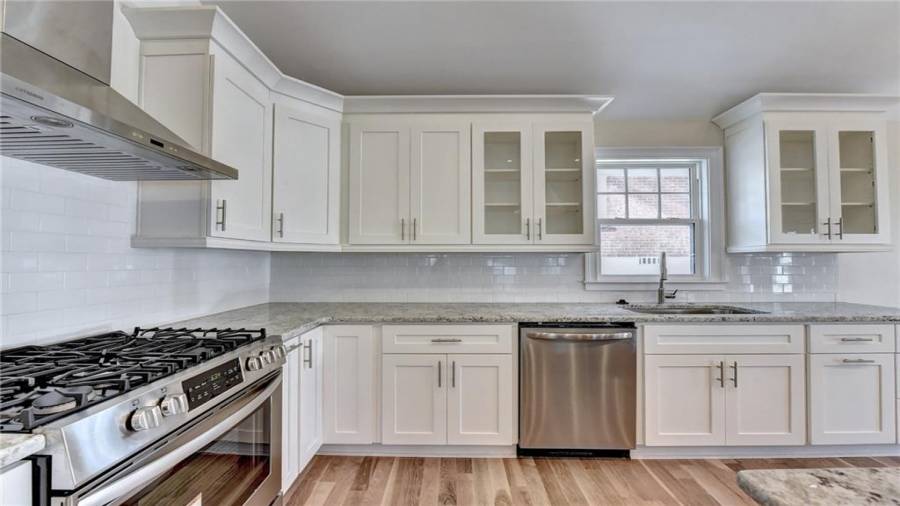 New stainless steel appliances - 5 burner gas stove, refrigerator, dishwasher, microwave, new white oak flooring