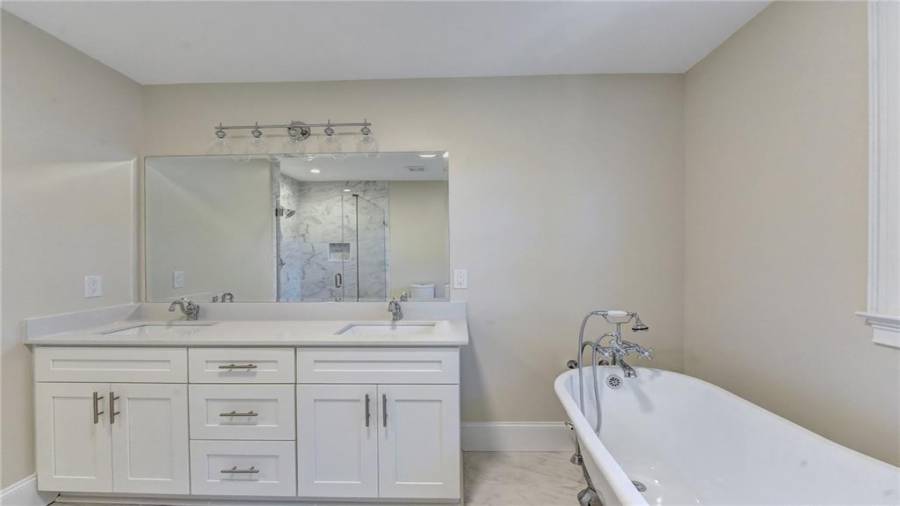 Dual vanities with Quartz, custom cabinets, designer lighting.