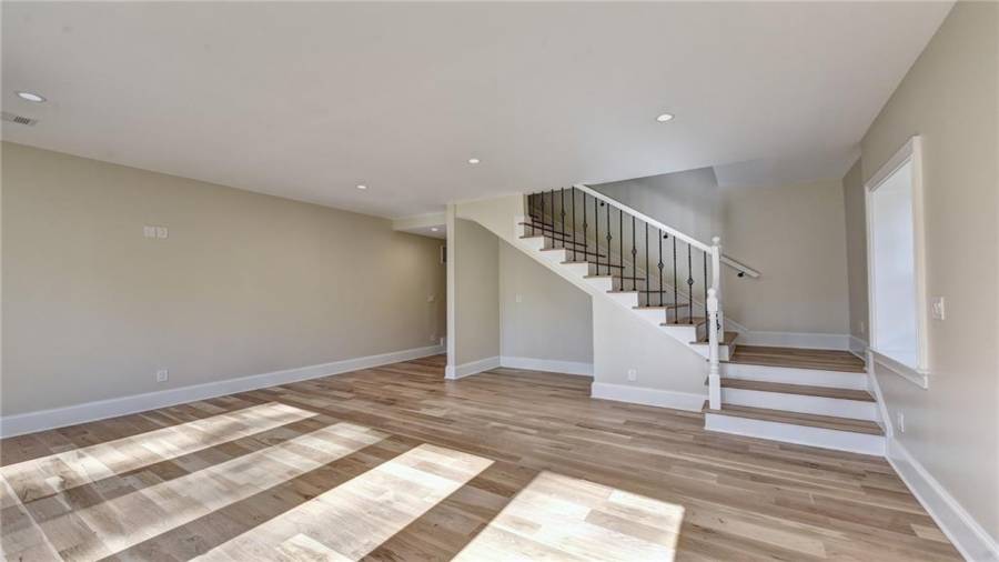 Daylight finished terrace level features new white oak flooring, double French doors to the patio and private back yard
