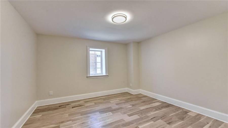 3rd bedroom in terrace level, new white oak flooring and new windows