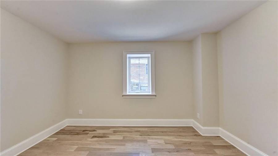 4th bedroom in terrace level with new white oak flooring and new windows