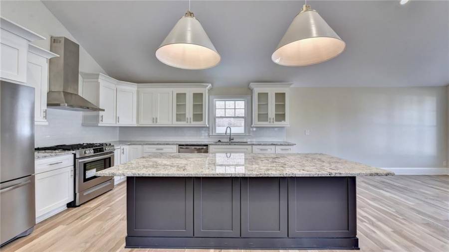 New custom cabinetry, new granite counter tops and tiled back splash, oversized island
