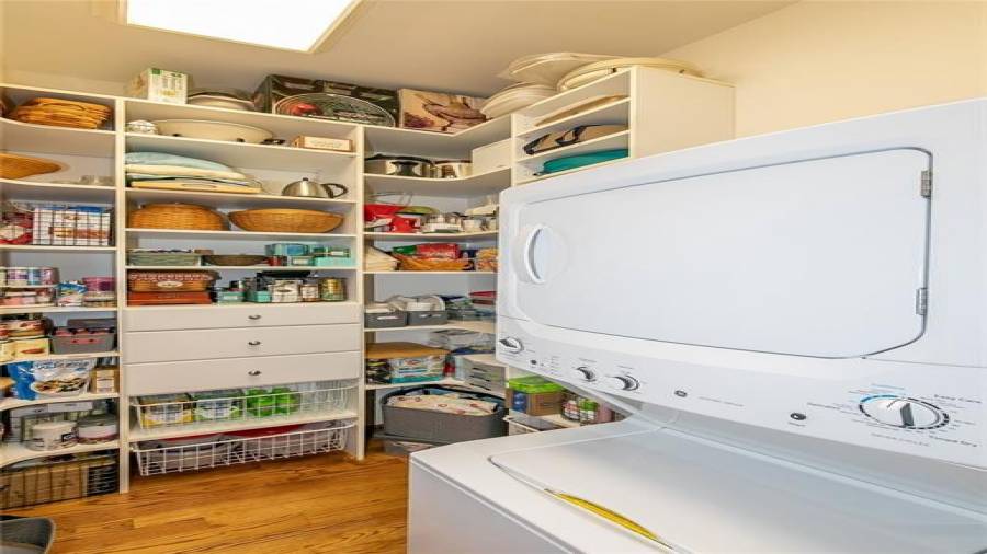 Pantry Off of Kitchen with Custom Shelving and Separate Stacked Washer/Dryer