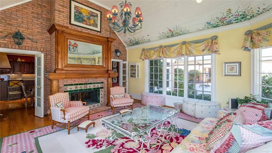 View from Garden Room into Kitchen. Exposed Brick Wall with Double Sided Fireplace.