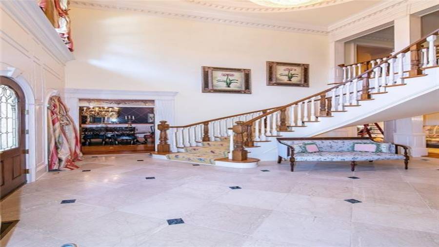 Breath-Taking 2-story Foyer with Marble Floors, Curved Staircase, and Swarovski Crystal Chandelier