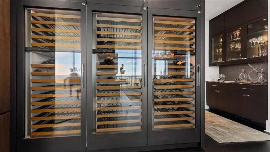 There are THREE Sub-Zero 146 Bottle Dual Zone Wine Coolers positioned off the foyer and adjacent to the bar.