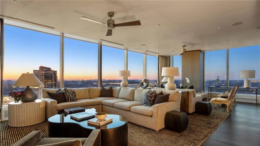 The Sunset and Buckhead Skyline Facing Den is 17 x 29 and Offers Stunning Views Of Buckhead and Midtown. Note Two Seating Areas and The Natural Gas Fireplace. The Kitchen Opens to This Space for A Casual Family Lifestyle And Effortless Entertaining.