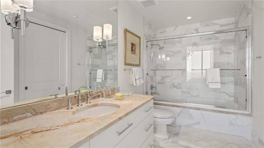 Third Bedroom (West Side of the home) Bath With White Carrera Marble Shower and Floors And Custom Marble Vanity.